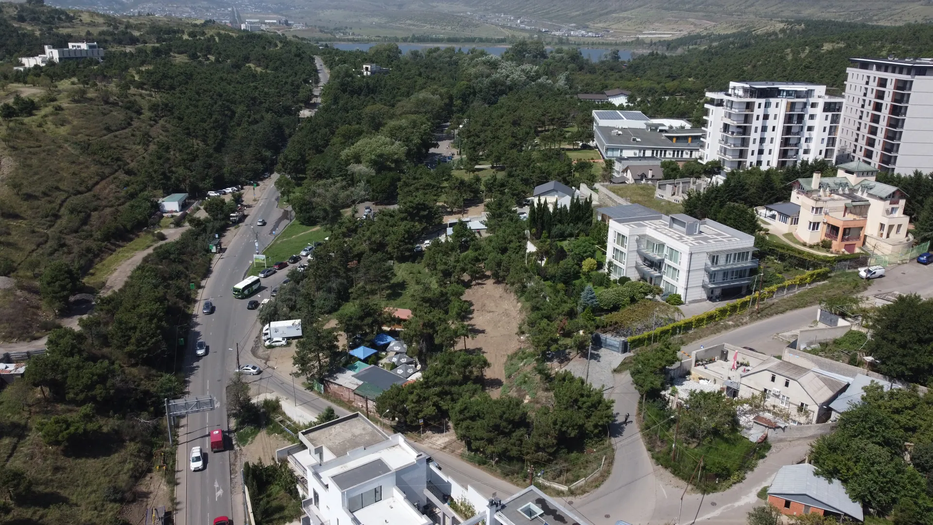 Drone photograph of the Lisi Lake site and the surrounding hillside, with Lisi Lake beyond — current condition, September 2026